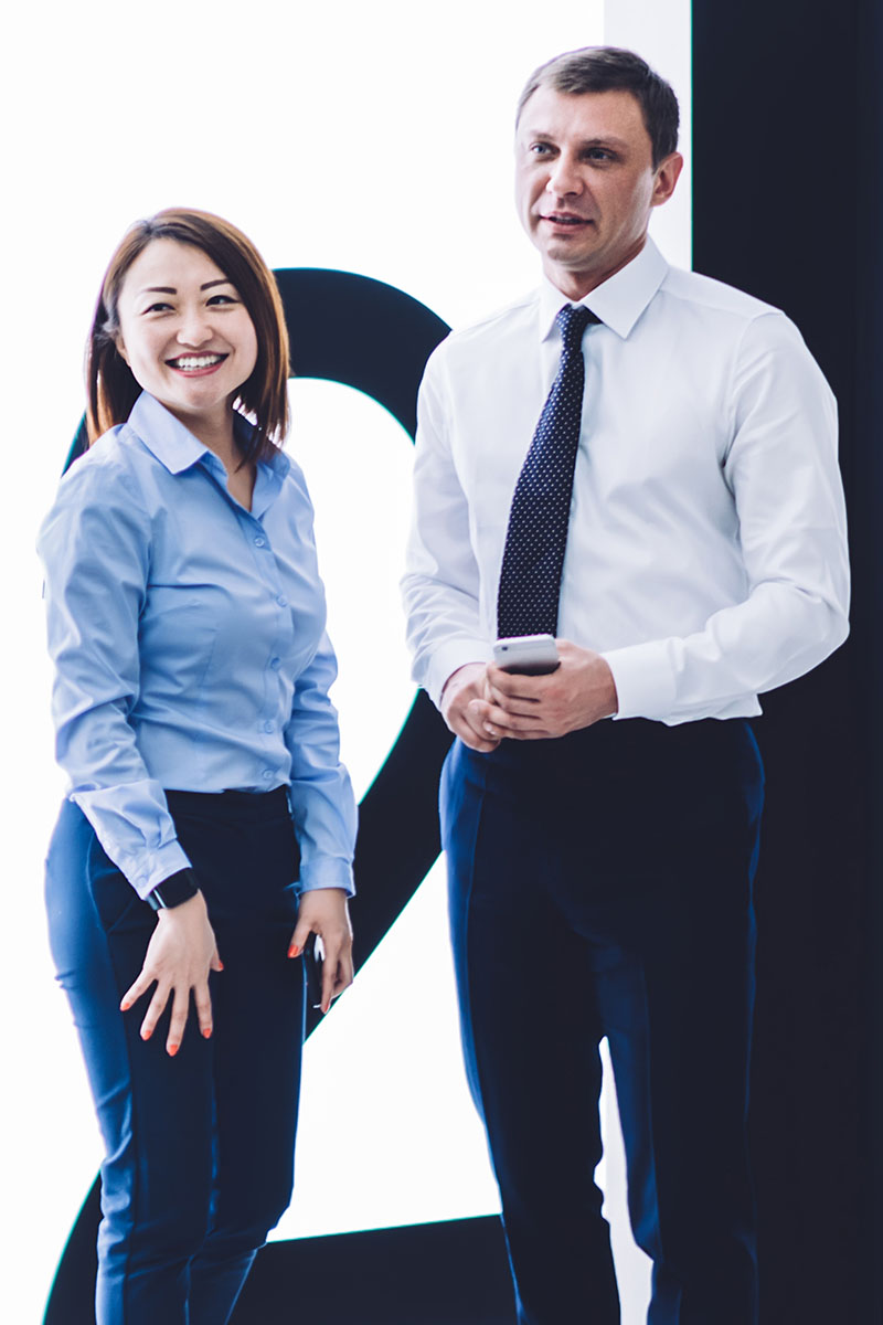 Corporate header 800x1200px Multiracial male and female corporate worked standing outside of an elevator