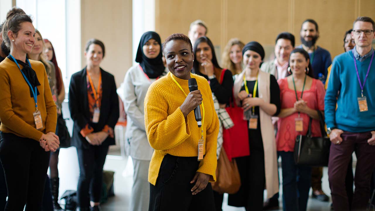 Drive Member Value 1280x720px female speaker address group at an association forum