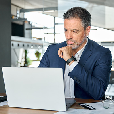 Executive Learning mobile 400x400px male professional siting in front of laptop engages with an executive learning course