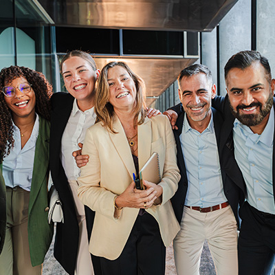 Organisations Header 400x400px Group of happy and smiling corporate employees neatly dressed, taking a team photo