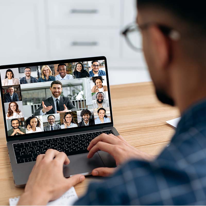 Portal Solutions page 800x800px Male viewing laptop with group of people on video conference
