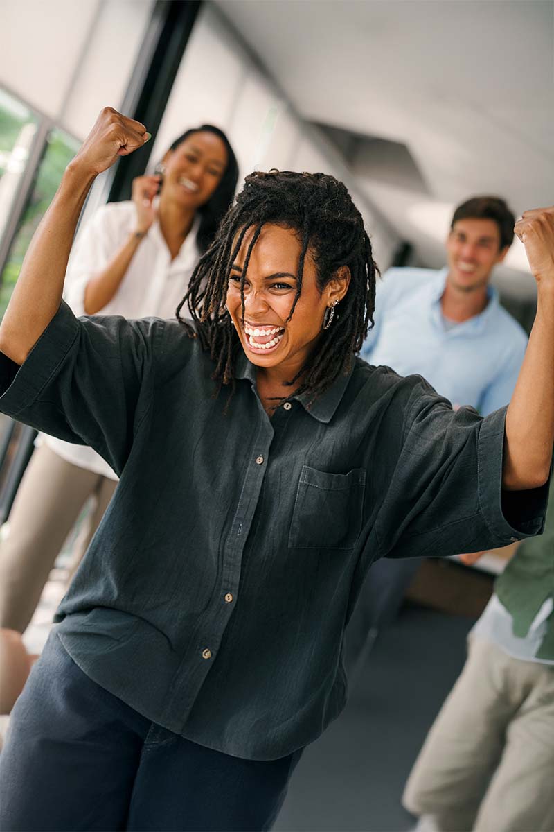 Supported Ready to go 800x1200px African amercian female with arms raised up with excitement and joy