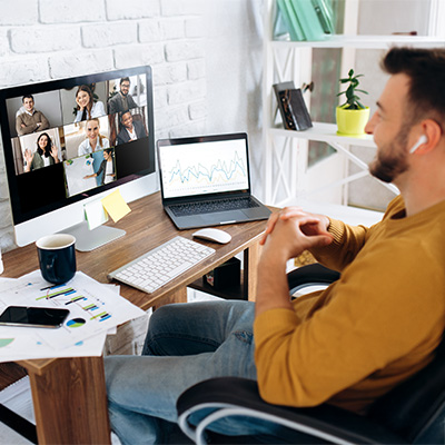 launch & scale mobile 400x400px male in home office videoconferencing team of people shown on laptop