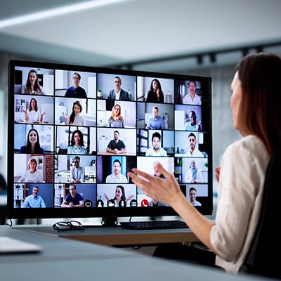 Female and male in front of laptop in meeting room discussing content on screen
