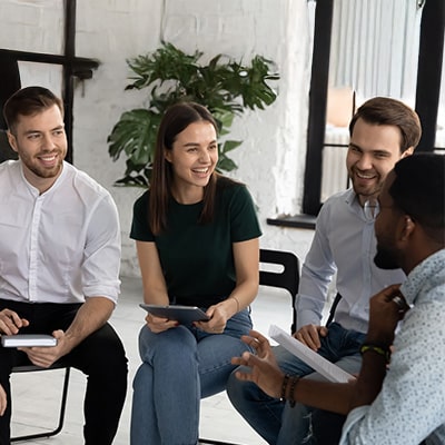 Team members sharing ideas and learning together in a group discussion